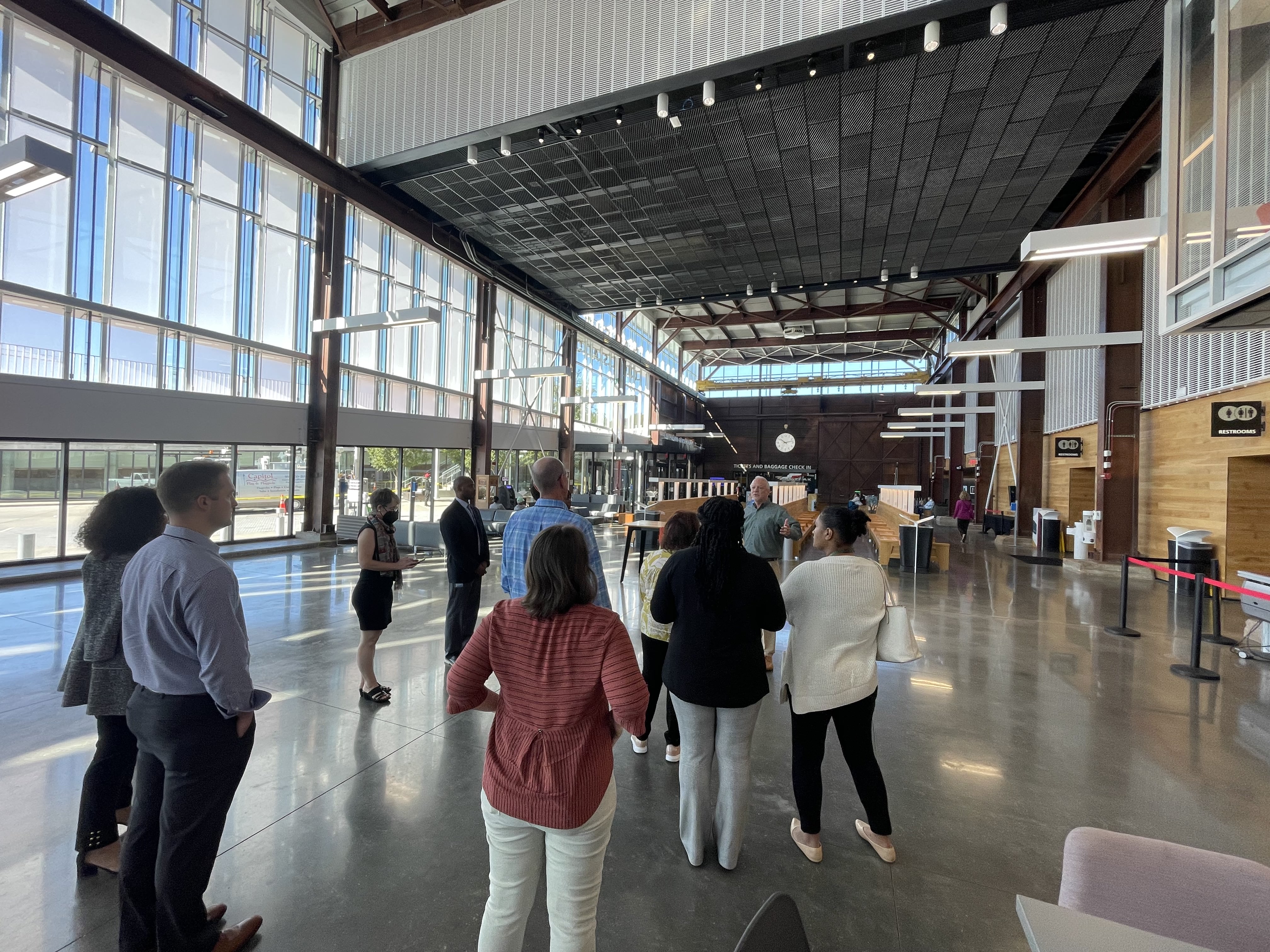 People gathered in the lobby of a building.